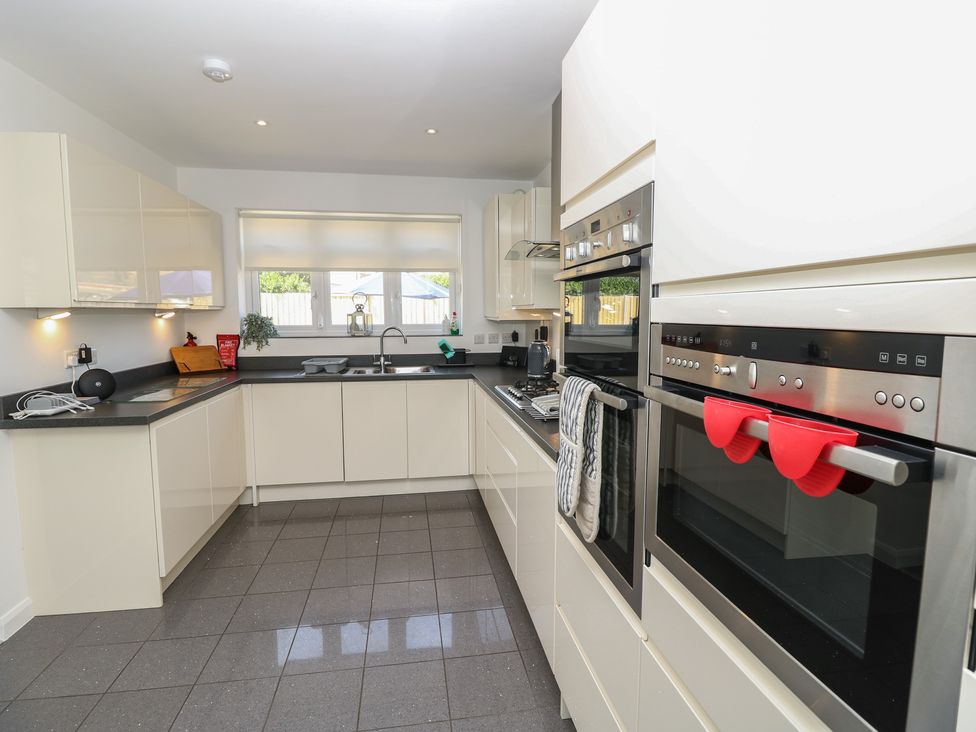 A kitchen with modern appliances and cabinetry at 50 Sea Road Milford On Sea