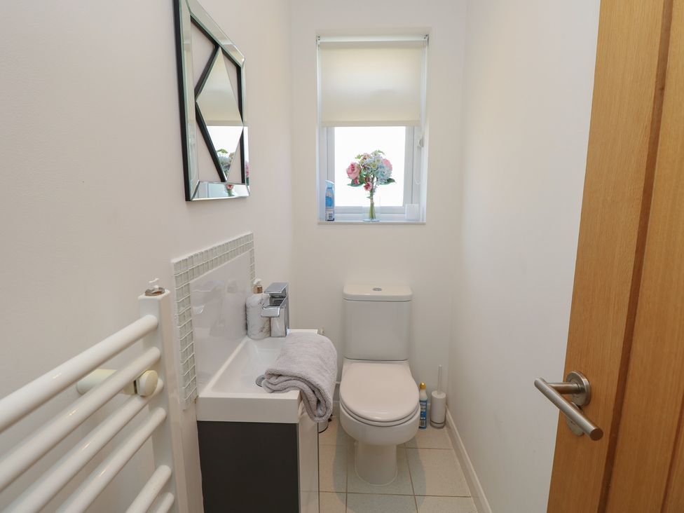 A bathroom with a toilet and sink at 50 Sea Road in Milford On Sea