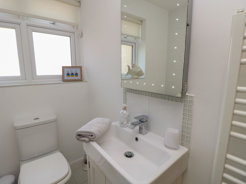 A bathroom with a sink and toilet at 50 Sea Road in Milford On Sea