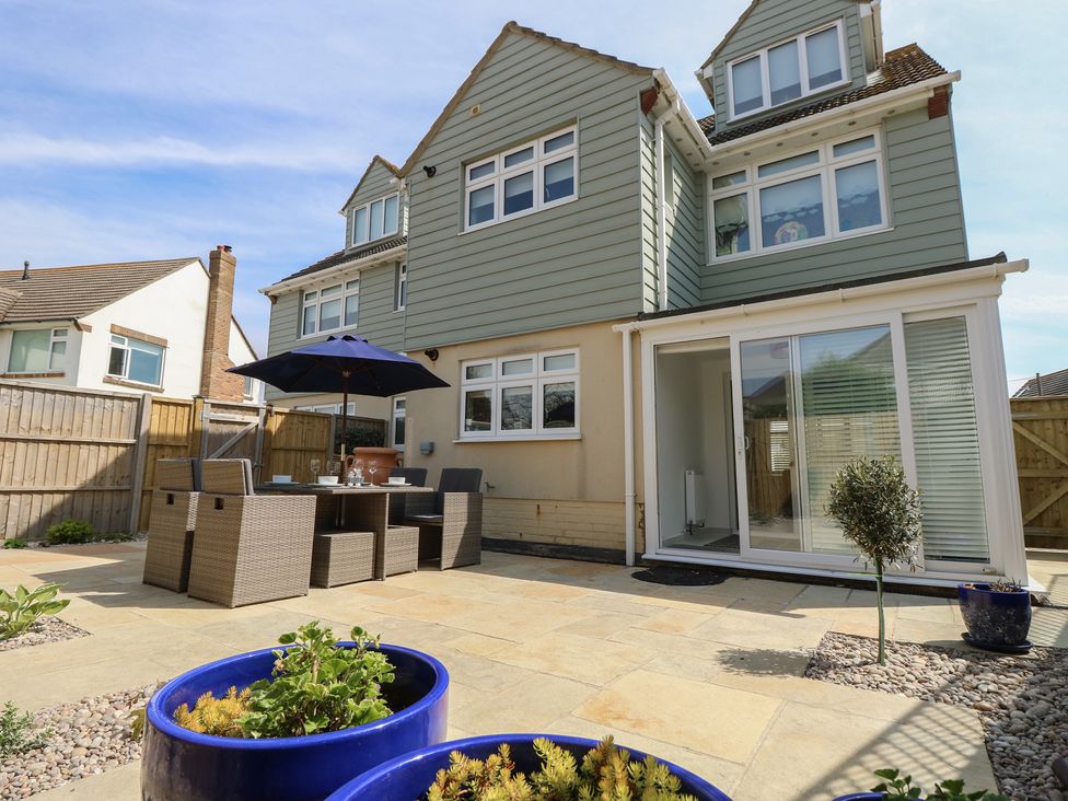 A garden with outdoor furniture and plants at 50 Sea Road in Milford On Sea