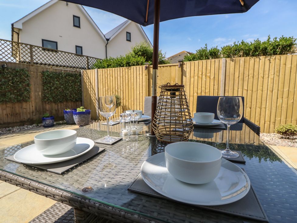 An outdoor dining area with a table set up at 50 Sea Road in Milford On Sea