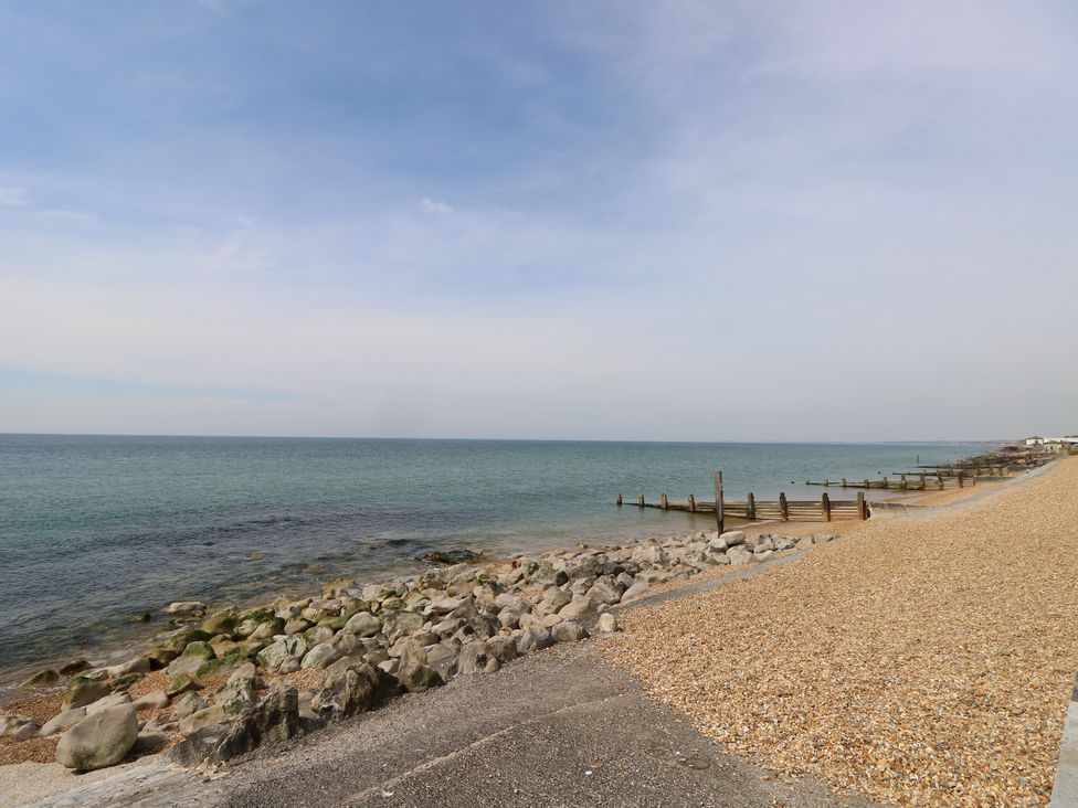 A beach with pebbles and a jetty at 50 Sea Road Milford On Sea