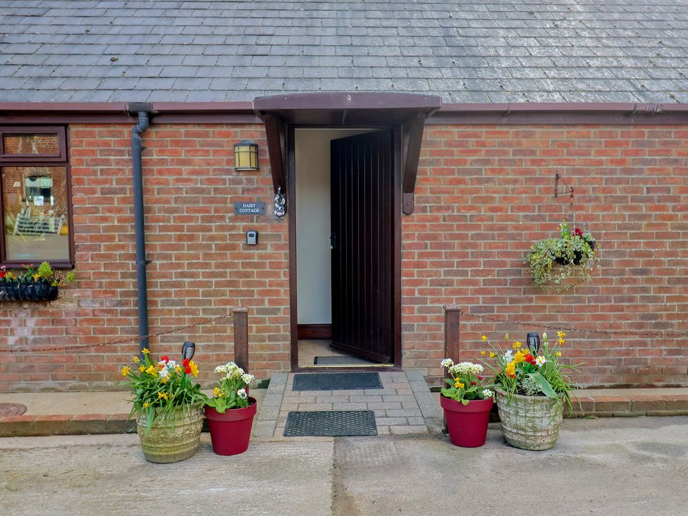 An entrance with flower planters at Daisy Cottage in Whitchurch Canonicorum near Charmouth
