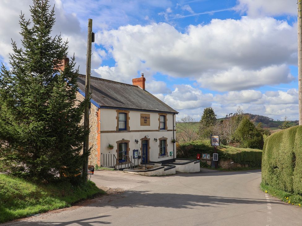 A building with signage and greenery at Daisy Cottage Whitchurch Canonicorum near Charmouth
