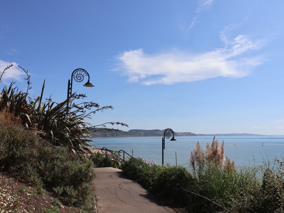 A walkway with a lamp post overlooking the ocean at Daisy Cottage Whitchurch Canonicorum near Charmouth