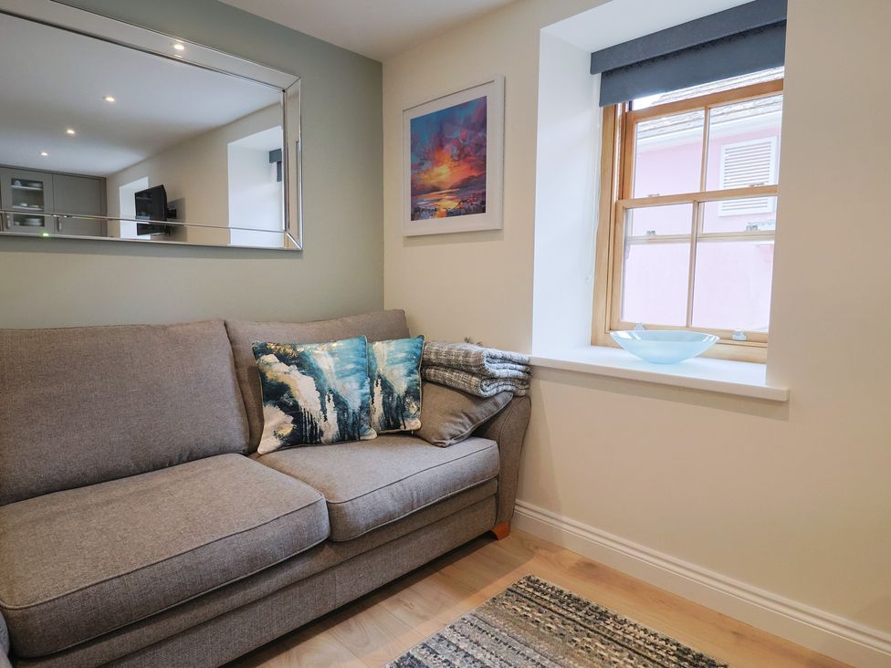 A living room with a sofa and window at Flat 2 The Cedars in Lyme Regis