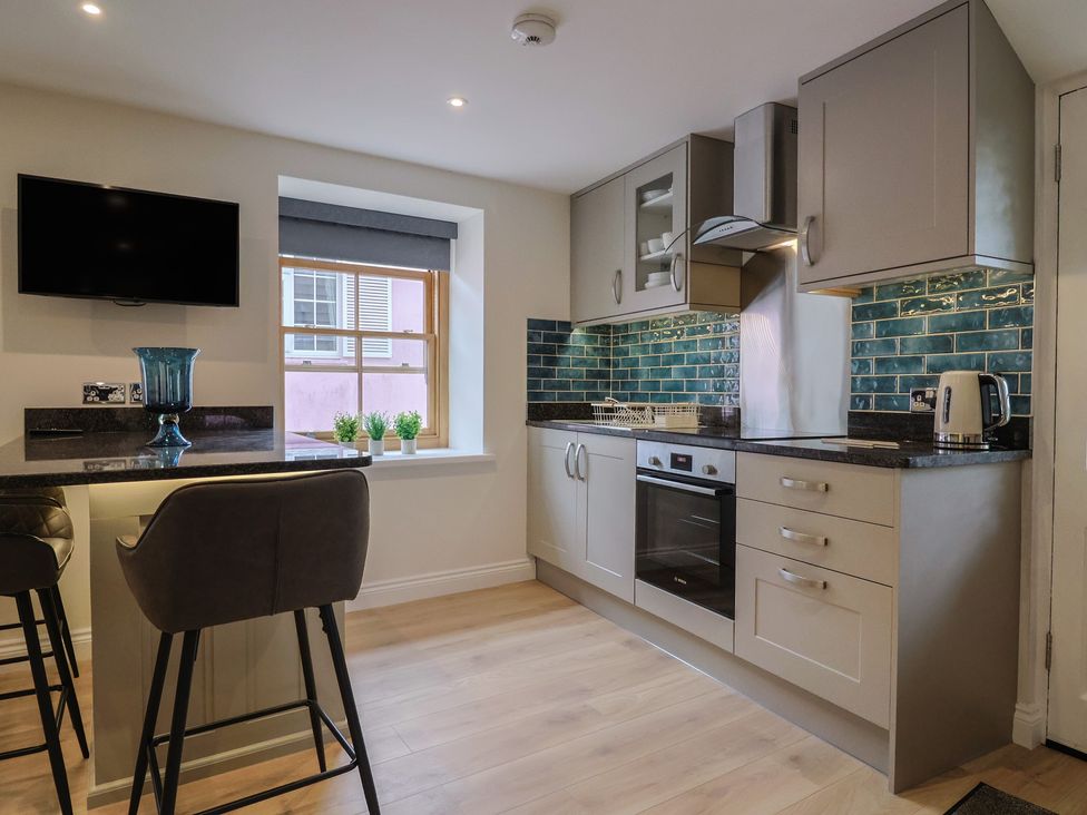 A kitchen with a stove and sink at Flat 2 The Cedars in Lyme Regis