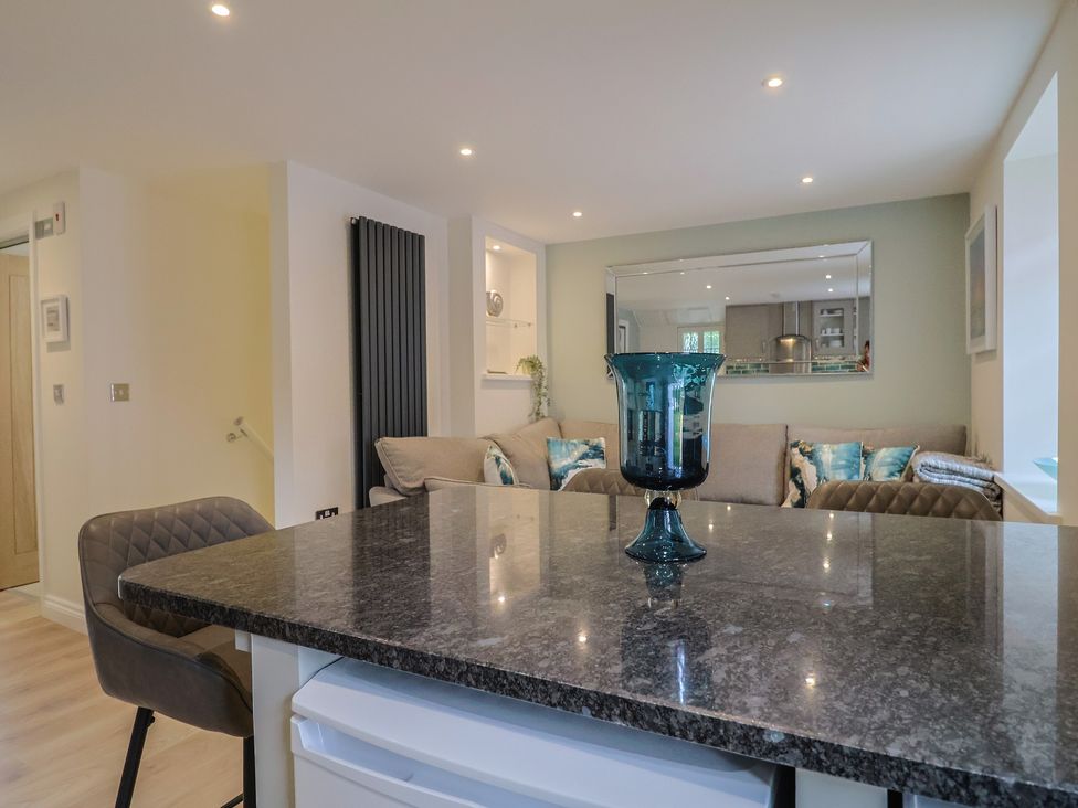 A living room featuring a sofa and coffee table at Flat 2 The Cedars in Lyme Regis