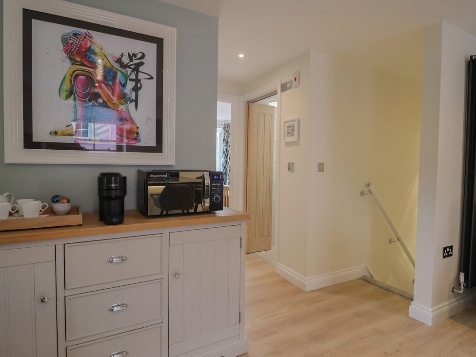 A kitchen with a coffee maker and microwave at Flat 2 The Cedars in Lyme Regis
