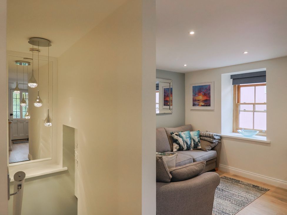 A living room with a sofa and a window at Flat 2 The Cedars in Lyme Regis