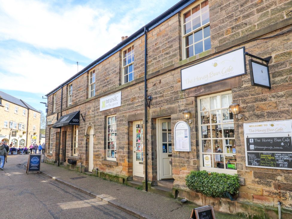An outdoor view of The Honey Bun Cafe with signage and windows in Bakewell