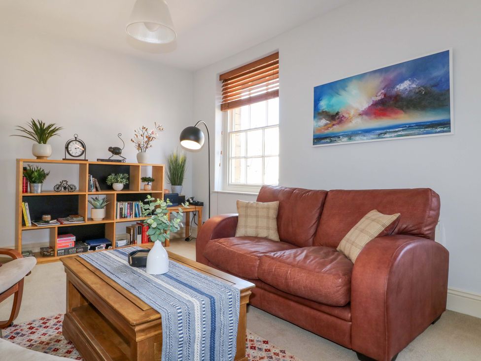 A living room with a sofa, coffee table and shelf at 2A Water Street Bakewell