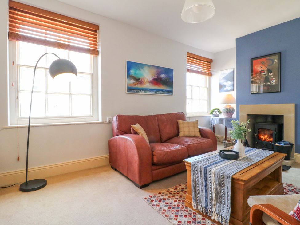 A living room with a sofa and fireplace at 2A Water Street, Bakewell