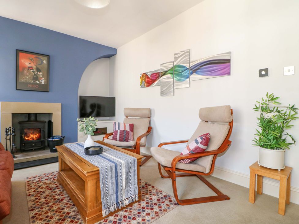 A living room with armchairs and a fireplace at 2A Water Street Bakewell