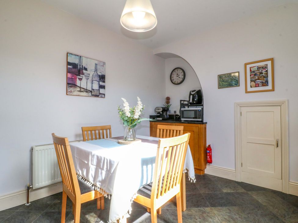 A dining room with a table and chairs at 2A Water Street Bakewell