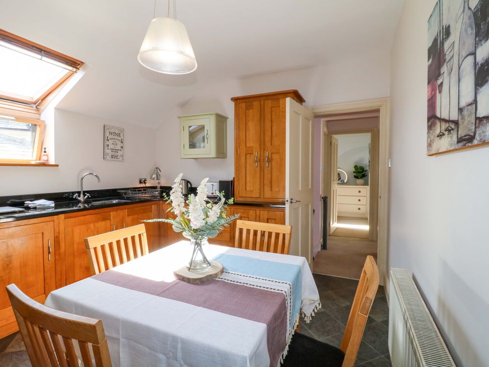A kitchen with table and chairs at 2A Water Street, Bakewell