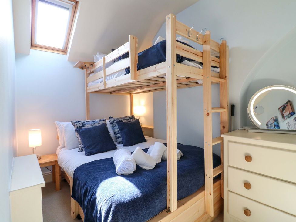 A bedroom with a bunk bed and a double bed at 2A Water Street Bakewell