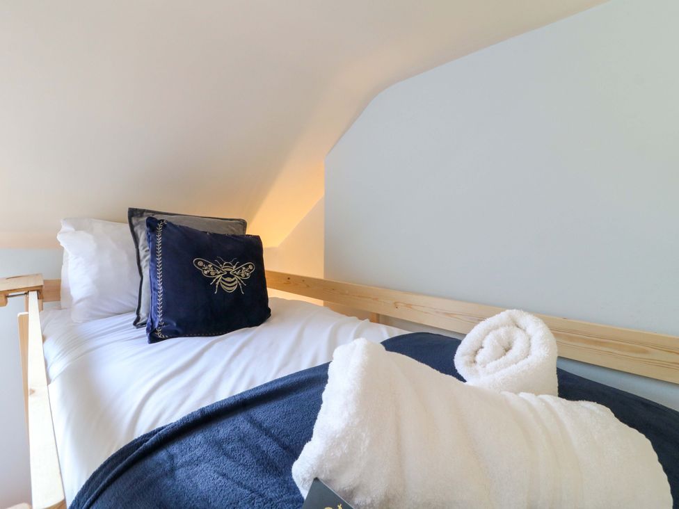 A bed with pillows and towels at 2A Water Street in Bakewell