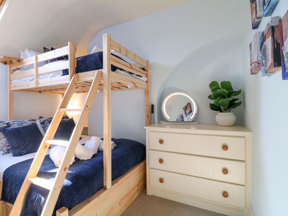 A bedroom with a bunk bed and dresser at 2A Water Street in Bakewell