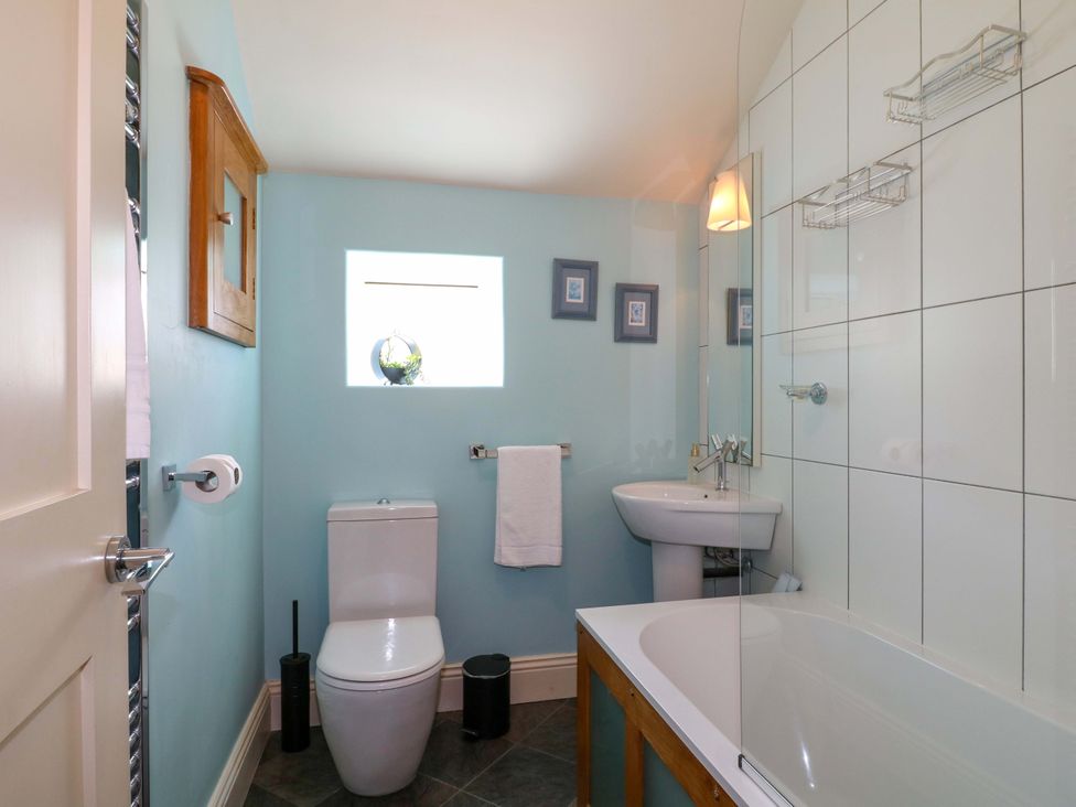 A bathroom with a toilet, sink, and bathtub at 2A Water Street, Bakewell