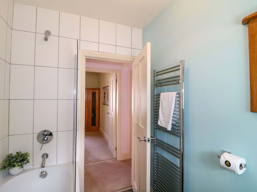 A bathroom featuring a bathtub and towel rail at 2A Water Street Bakewell