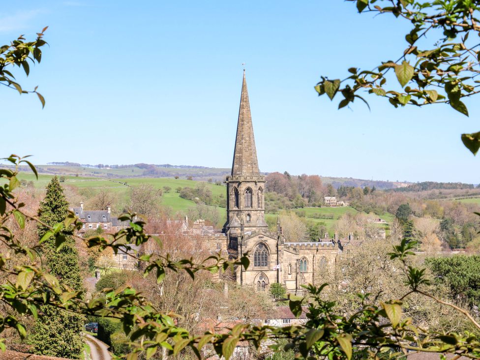 A church with a steeple in a rural landscape at 2A Water Street Bakewell