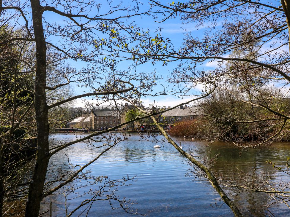 A view of a lake surrounded by trees and buildings at 2A Water Street Bakewell