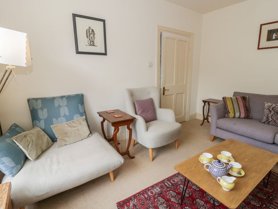 A living room with two sofas, a side table, and tea set at Ty Clyd in Newport, Pembrokeshire