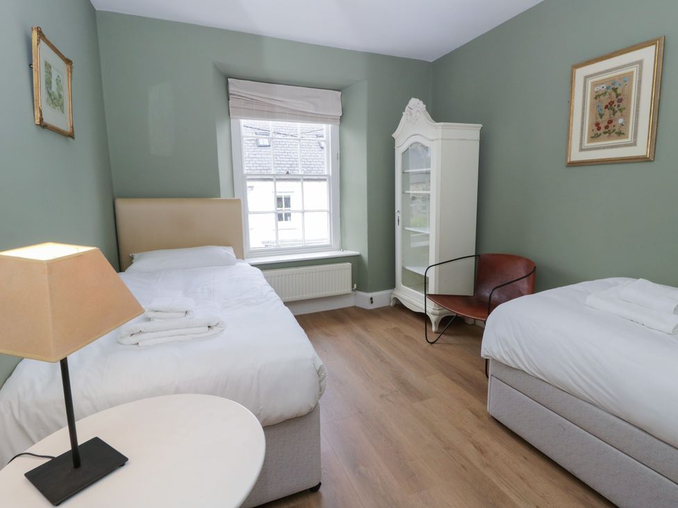 A bedroom with two beds and a window at Ty Clyd in Newport, Pembrokeshire