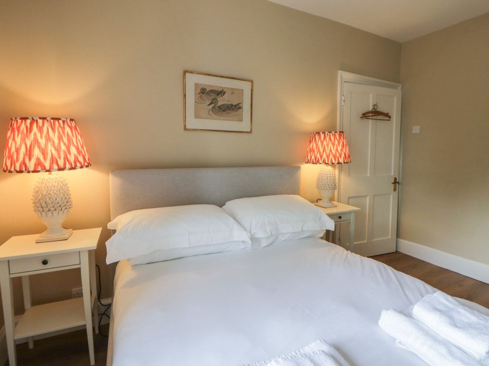A bedroom with a bed and lamps at Ty Clyd in Newport, Pembrokeshire