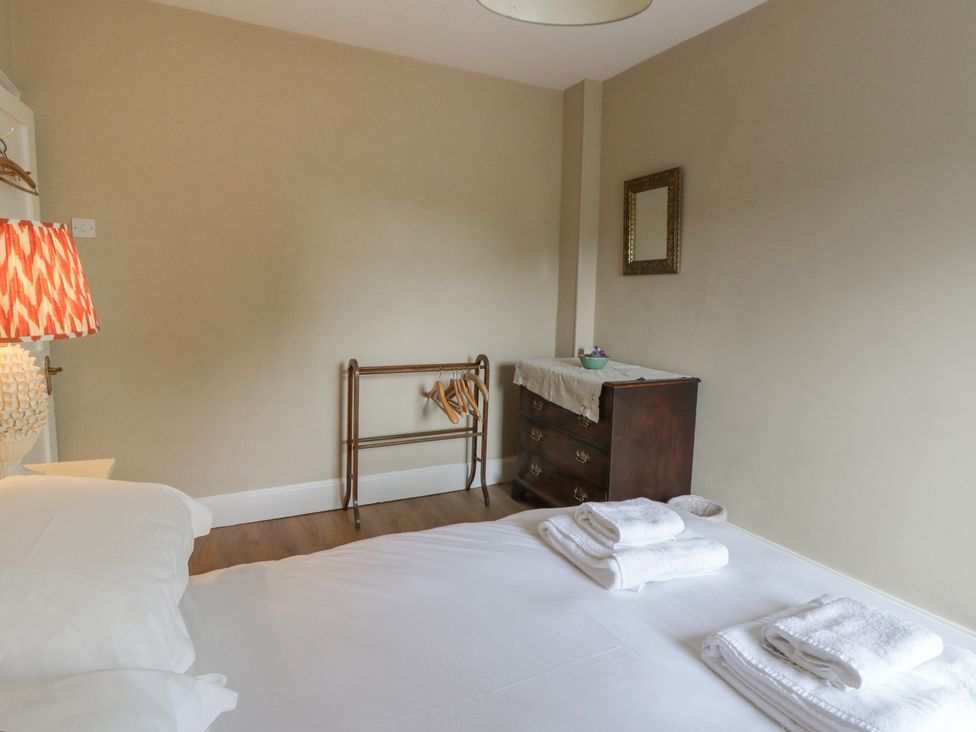A bedroom with a bed and towels on it at Ty Clyd in Newport, Pembrokeshire