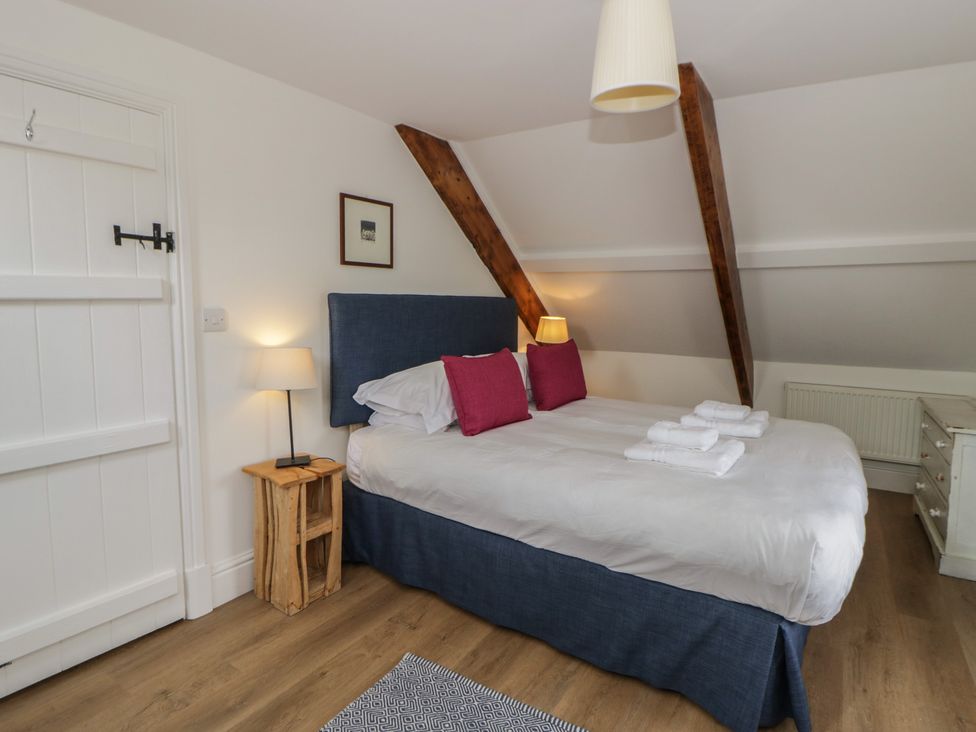 A bedroom with a double bed and bedside table at Ty Clyd in Newport, Pembrokeshire