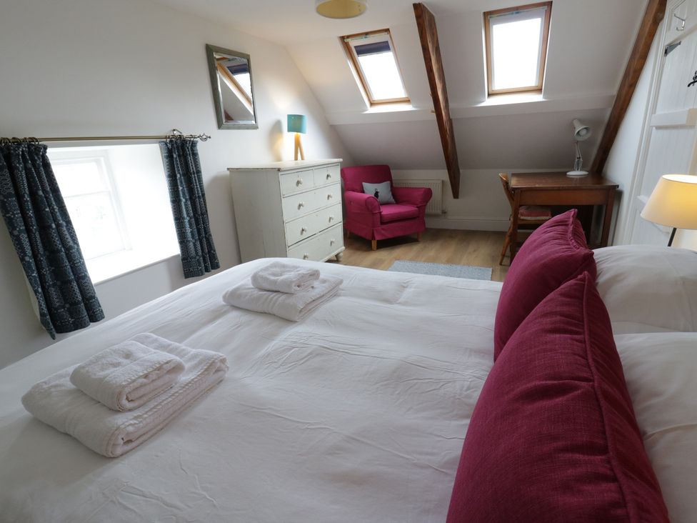 A bedroom with a bed and desk at Ty Clyd in Newport, Pembrokeshire