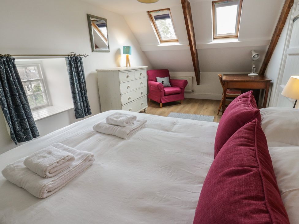 A bedroom with a bed and dresser at Ty Clyd in Newport, Pembrokeshire