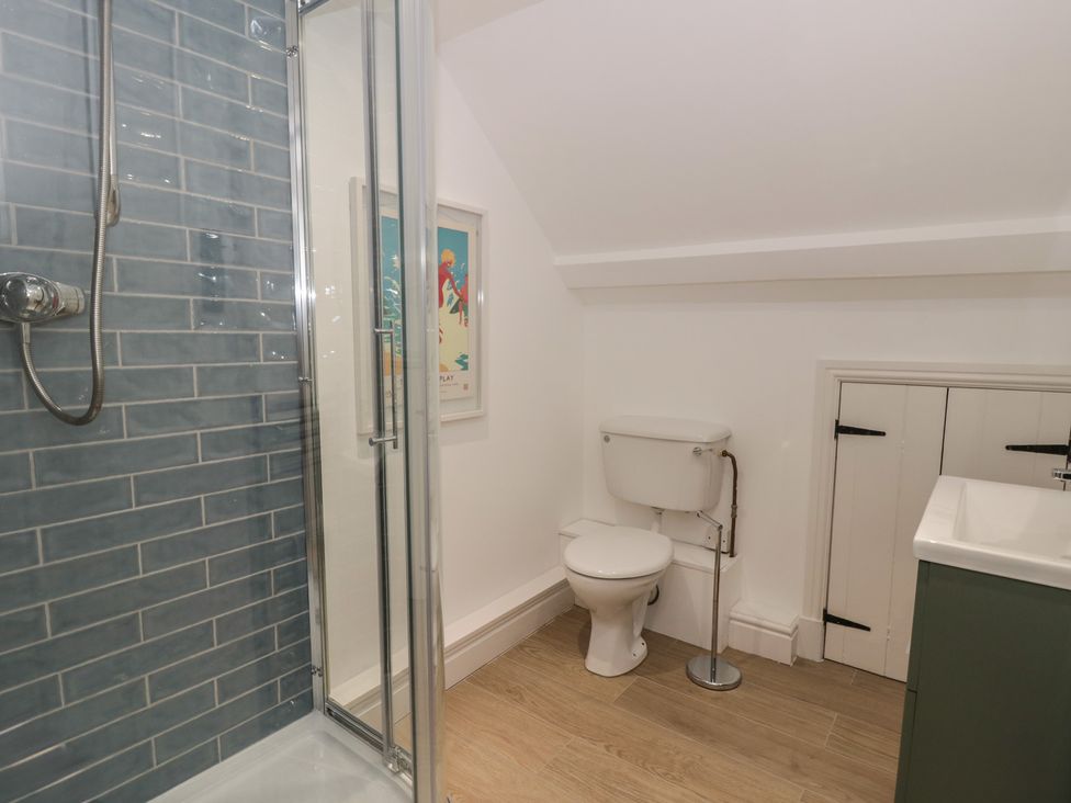 A bathroom with a shower and toilet at Ty Clyd in Newport, Pembrokeshire