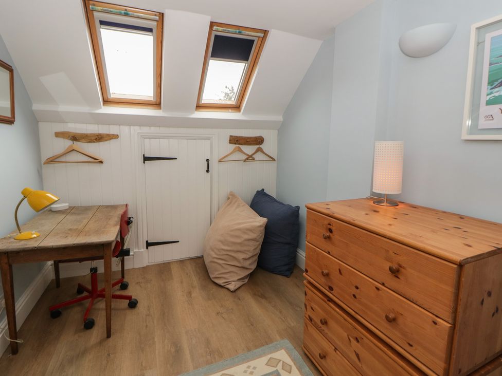 A bedroom with a desk and a chest of drawers at Ty Clyd in Newport, Pembrokeshire