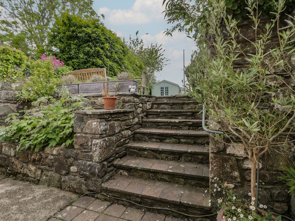 A garden with stone steps and plants at Ty Clyd in Newport, Pembrokeshire