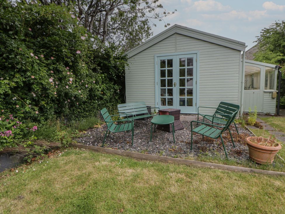 A outdoor seating area with chairs and a table at Ty Clyd Newport, Pembrokeshire