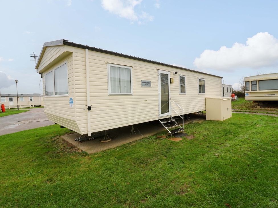 A mobile home with windows and steps at Meadowside