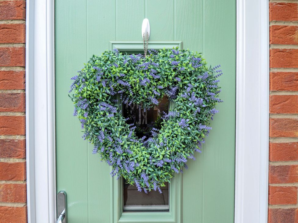 A heart-shaped wreath on a green door at Denholme in Hogsthorpe