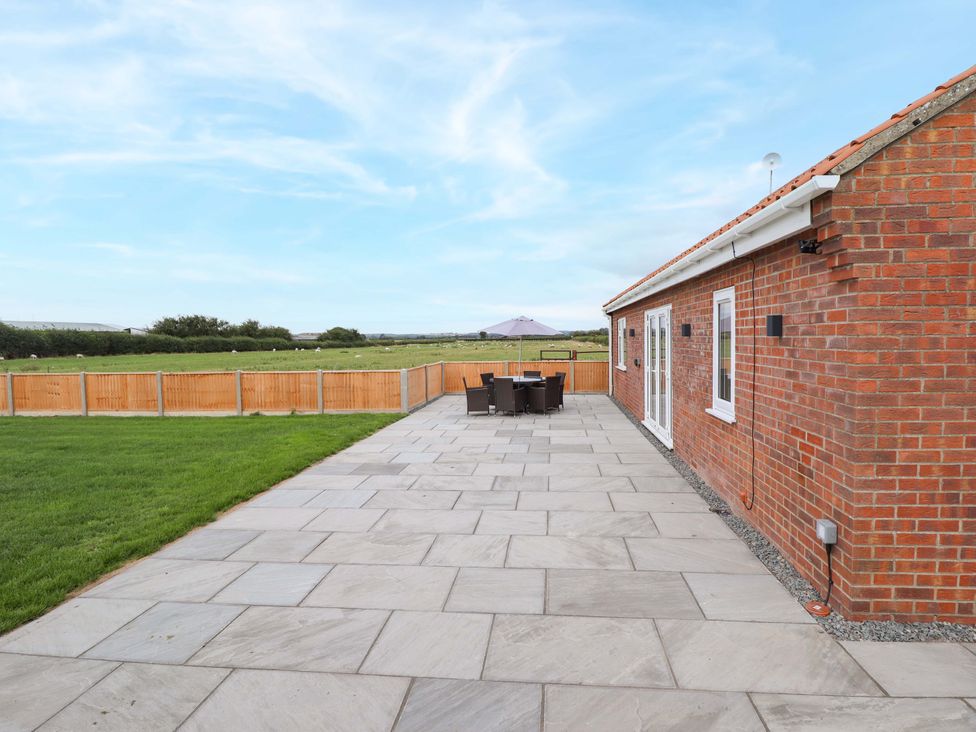 A patio area with garden furniture at Denholme in Hogsthorpe