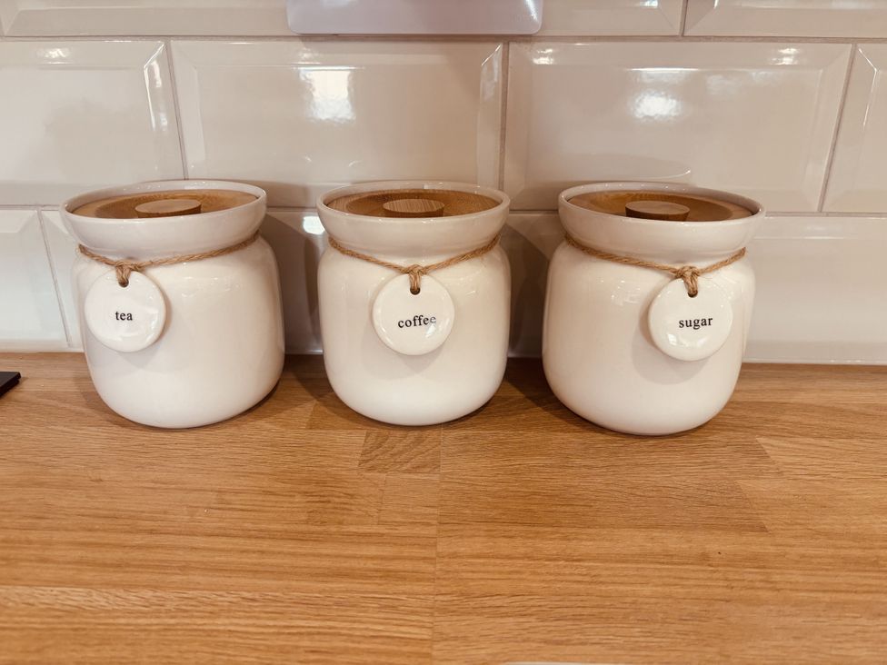 Three containers for tea, coffee, and sugar on a kitchen countertop at Denholme Hogsthorpe