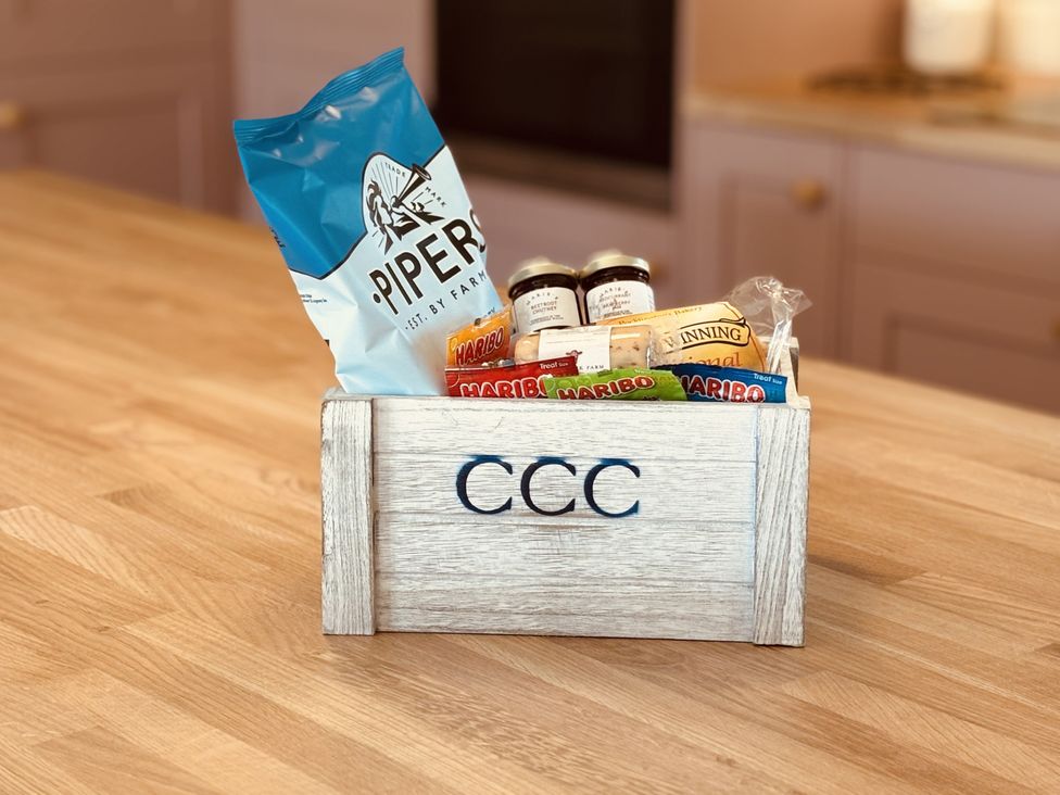 A wooden box filled with snacks at Denholme in Hogsthorpe