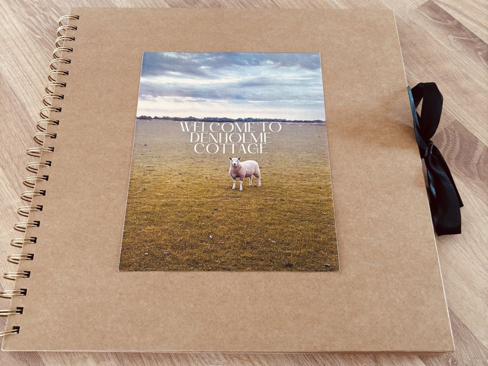 A notebook cover with an image of sheep at Denholme Cottage in Hogsthorpe