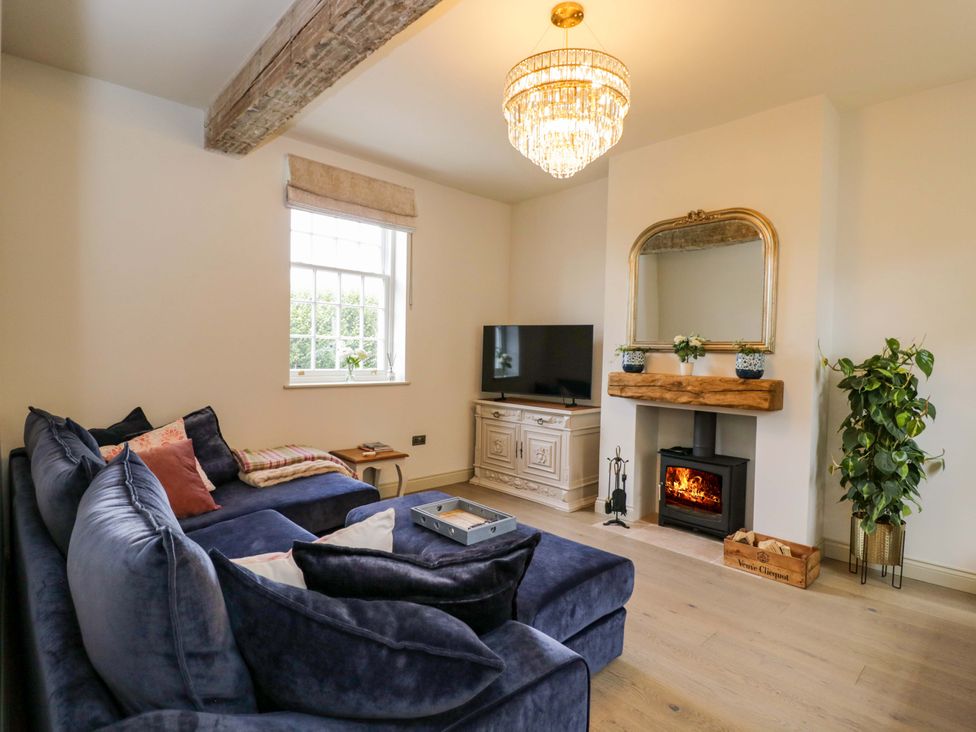 A living room with a sofa and television at Beech in Newbury