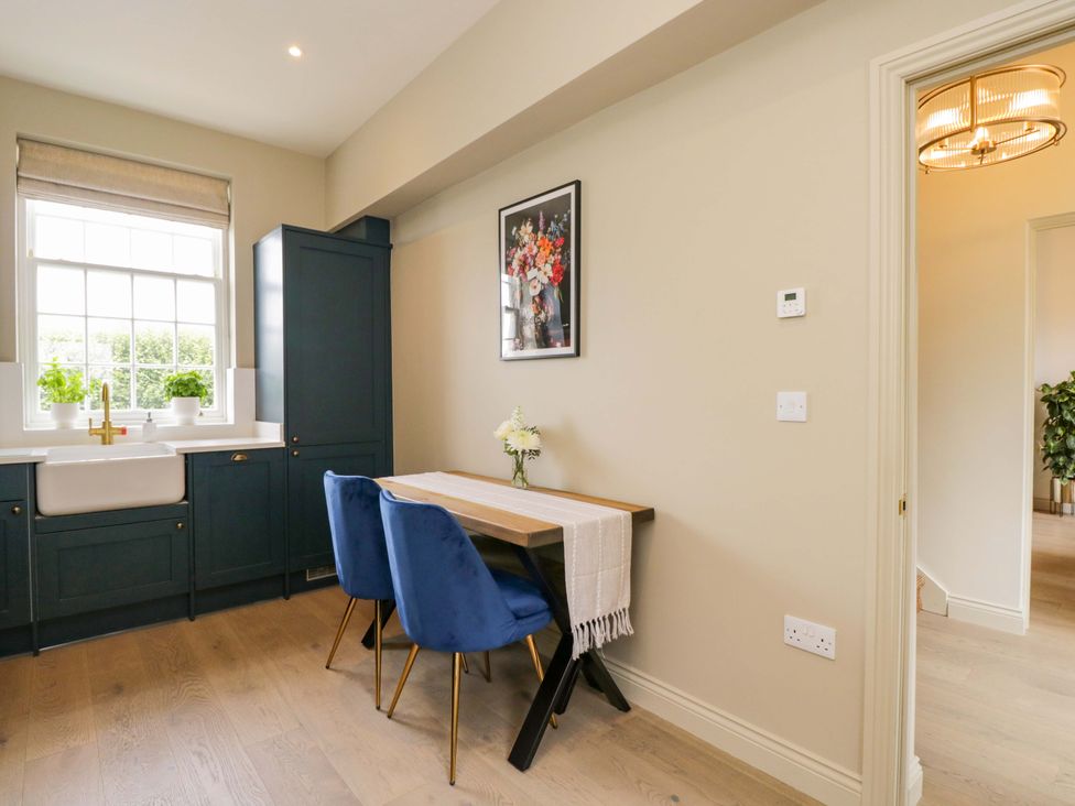 A kitchen with a dining table and chairs at Beech in Newbury