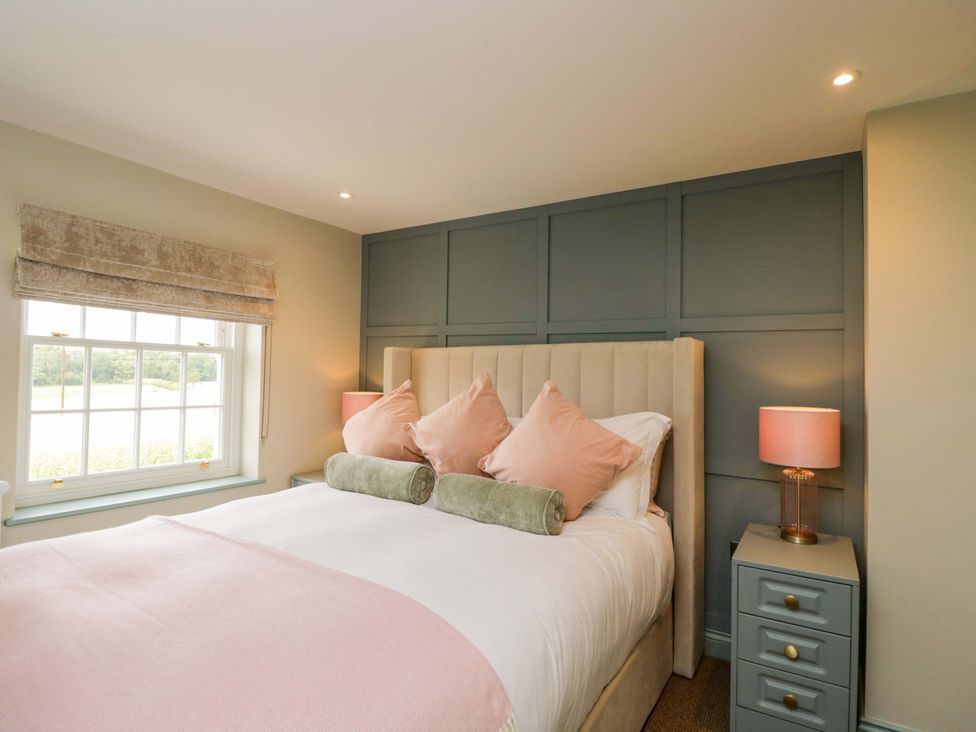 A bedroom with a bed and nightstand at Beech in Newbury