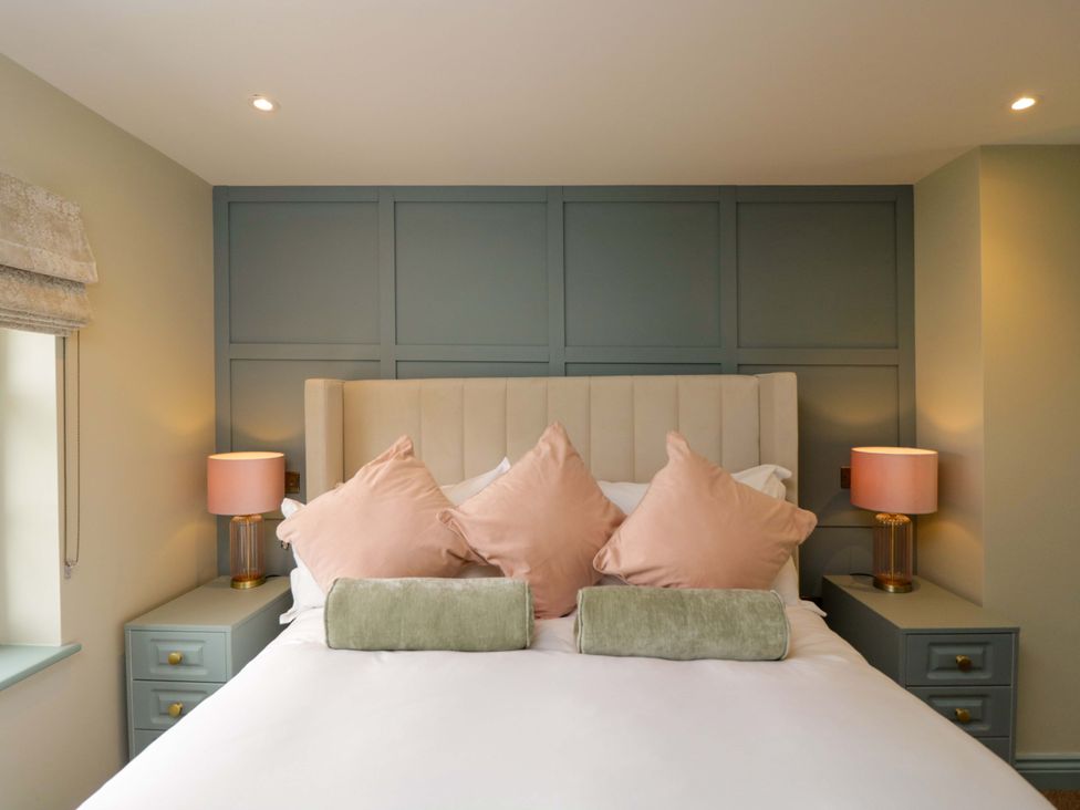 A bedroom with a bed and pillows at Beech in Newbury