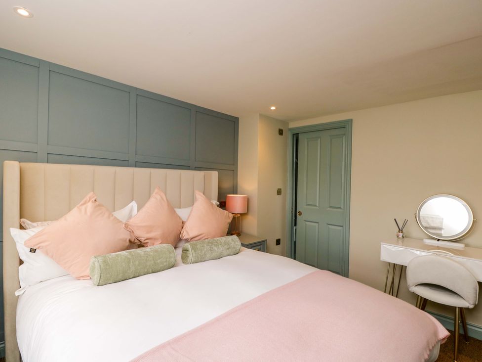 A bedroom with a bed and vanity at Beech in Newbury