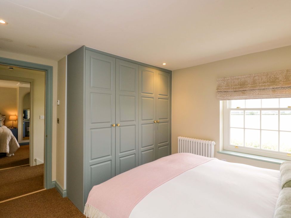 A bedroom with a bed and wardrobe at Beech in Newbury